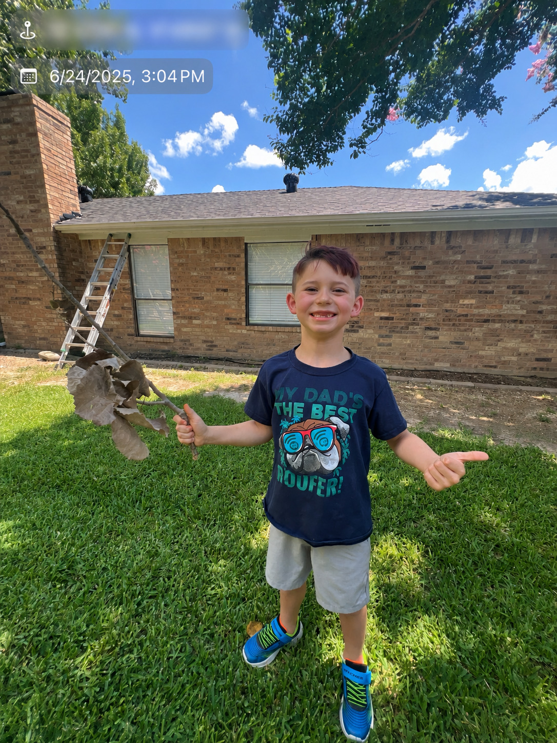 MVP owner's son proudly standing in front of a residential roofing project
