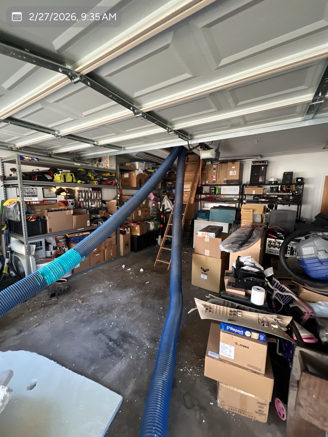 Insulation installation hoses routed safely through the garage to the attic