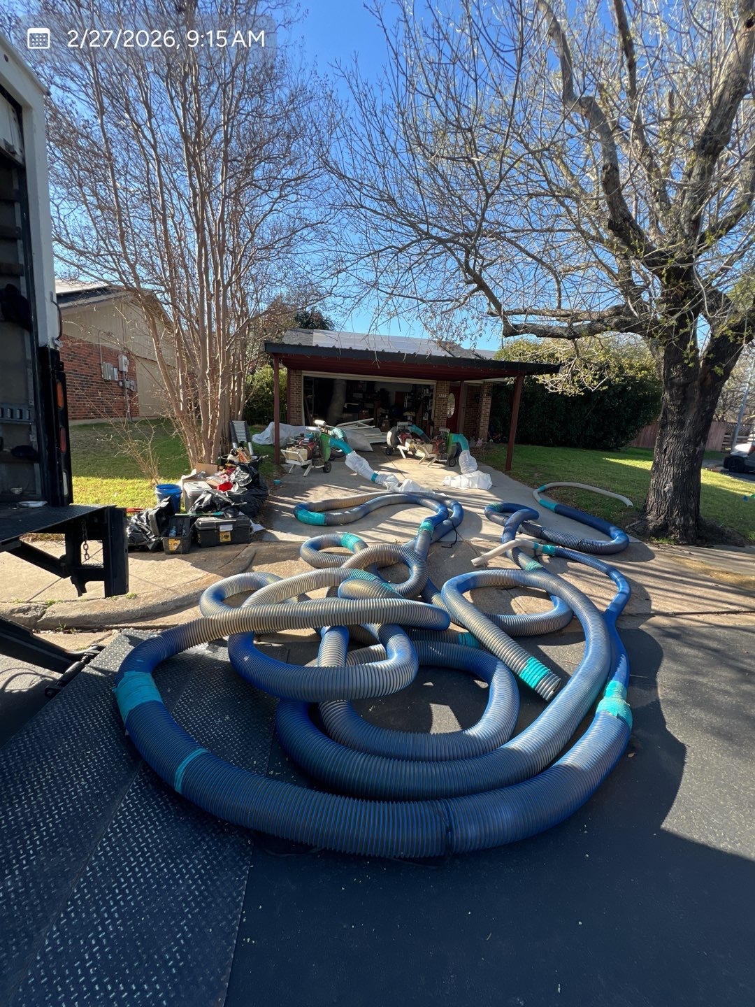 Hoses and equipment set up for an MVP attic insulation project