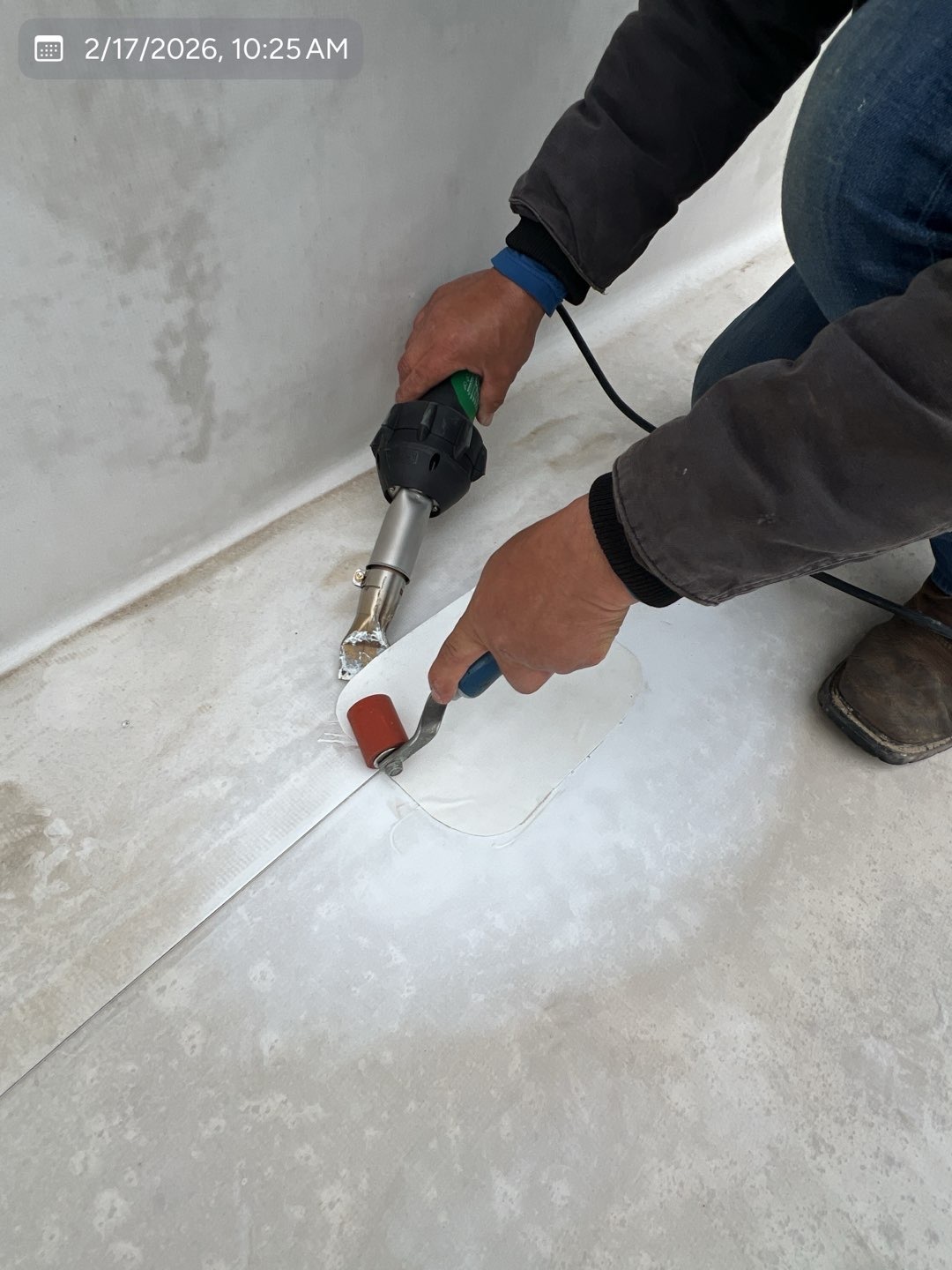 MVP technician heat-welding a repair patch onto a commercial TPO roof