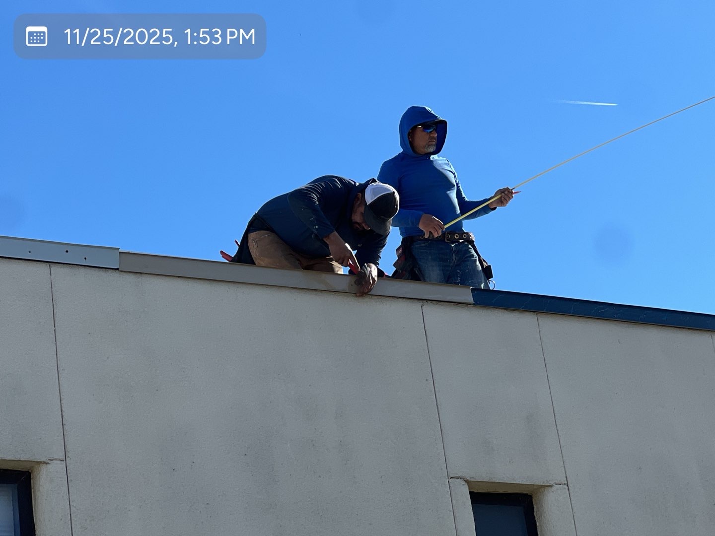 MVP crew measuring and fastening coping metal on a commercial building