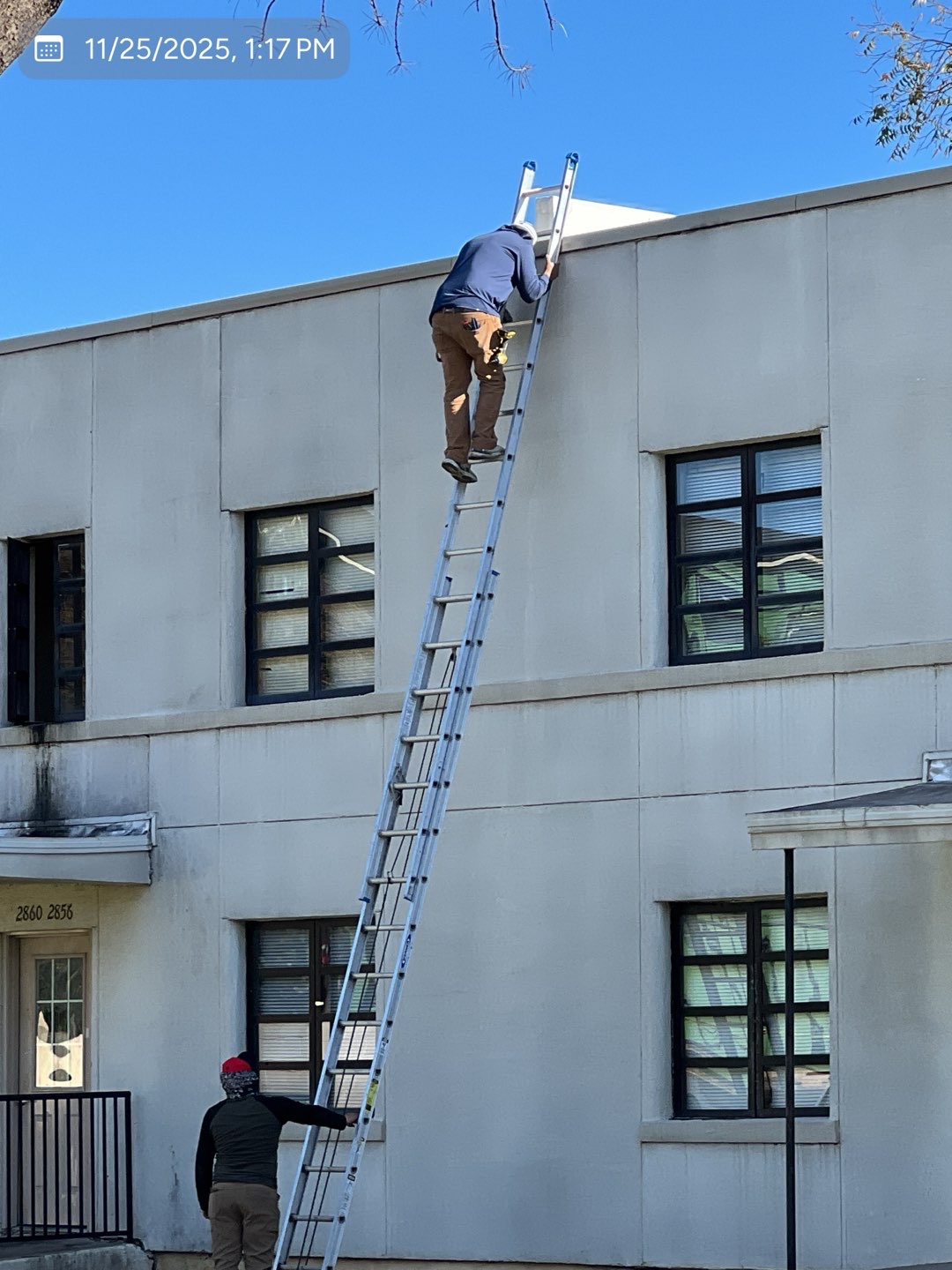 MVP crew positioning coping metal along a commercial parapet wall