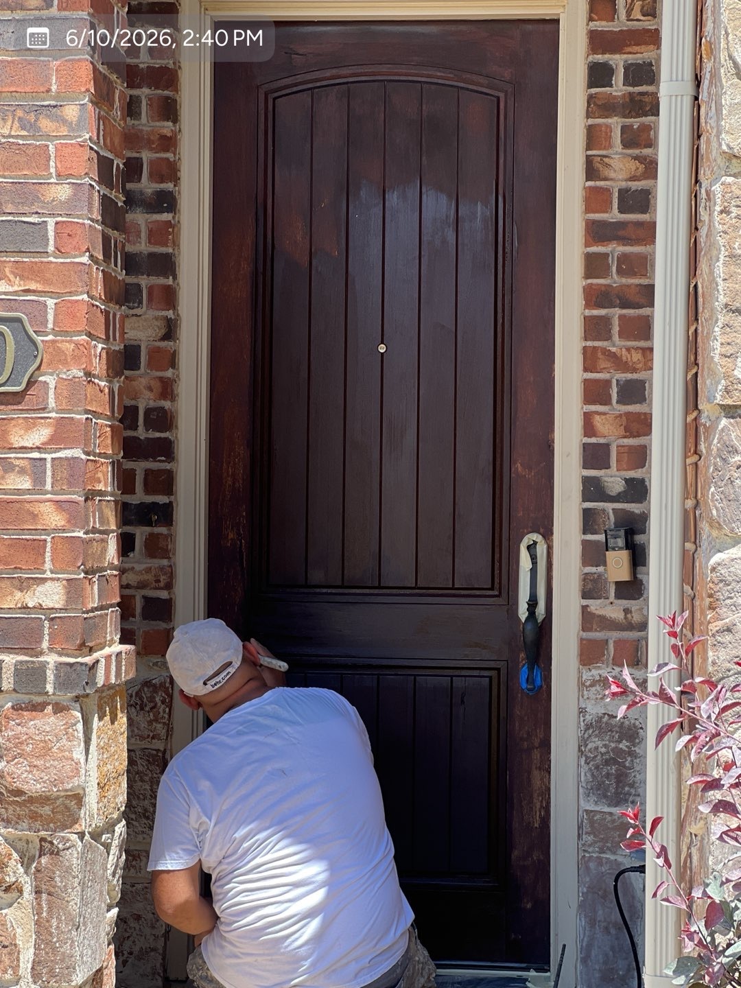 MVP crew member applying an exterior finish to a residential front door