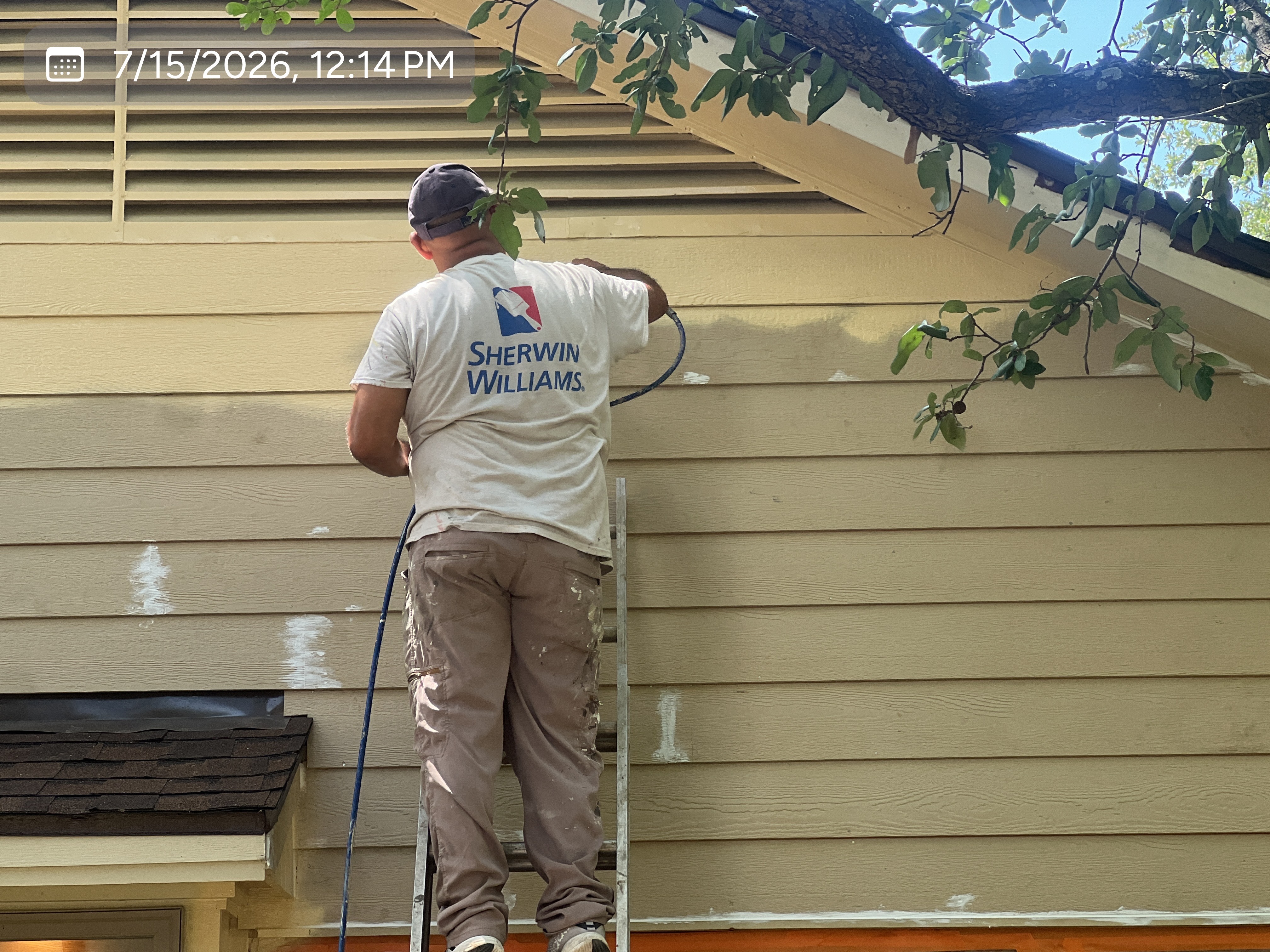 MVP crew member applying an exterior finish to residential siding