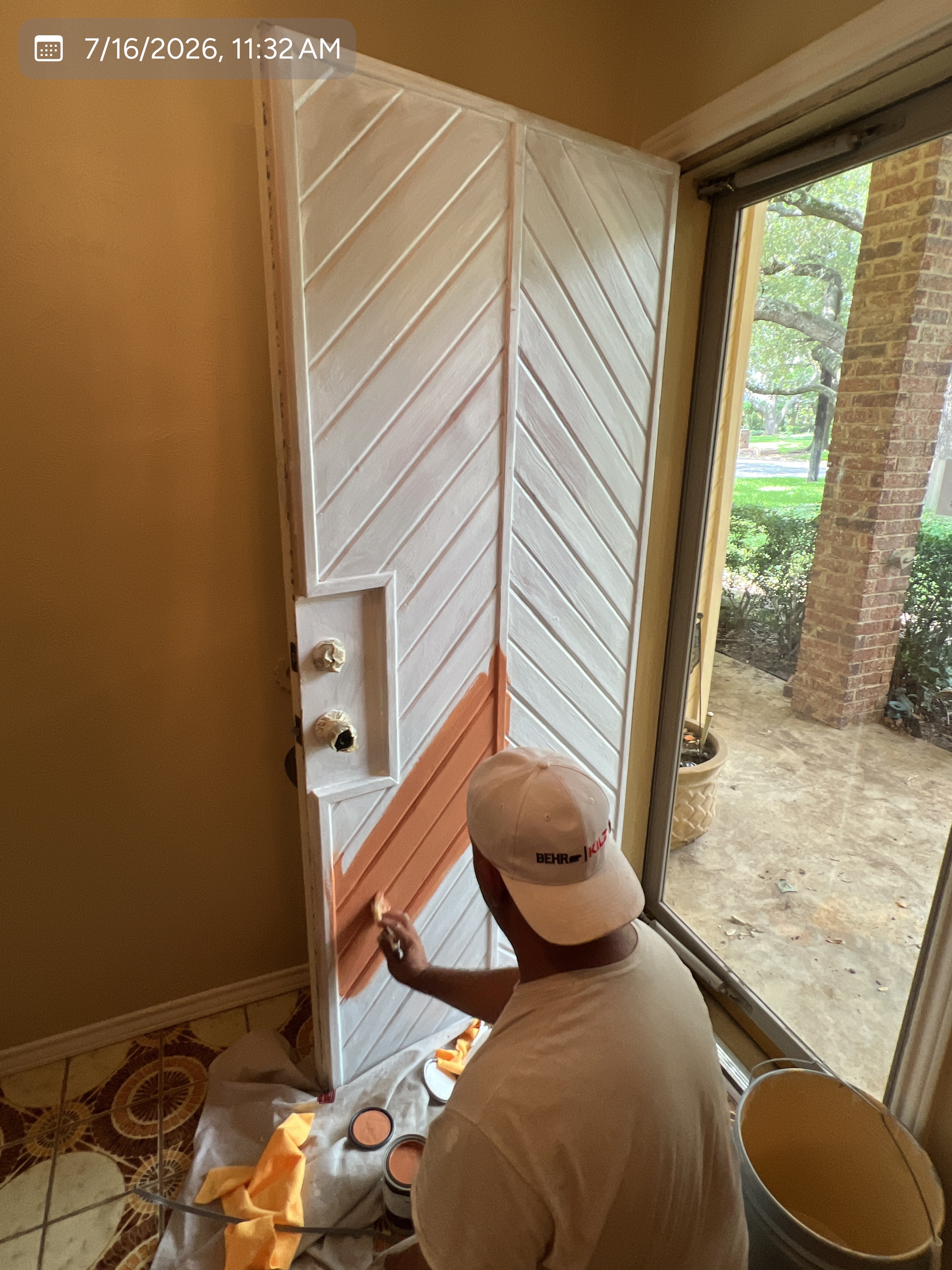 MVP crew member painting a residential front door
