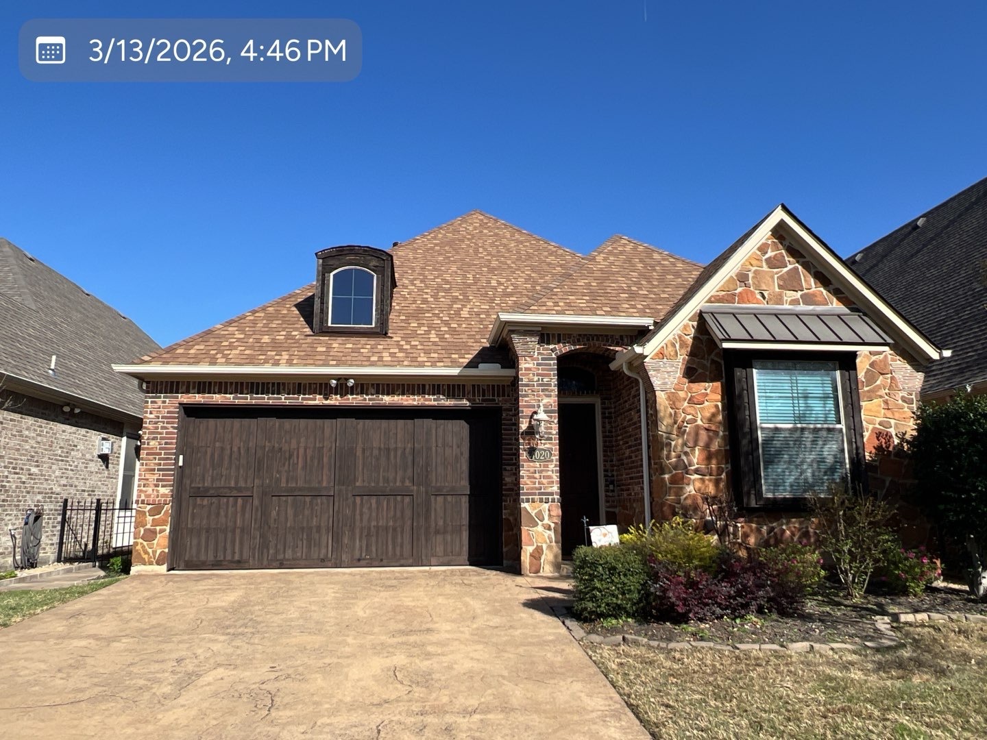 Completed gutter installation across the front roofline of a DFW home