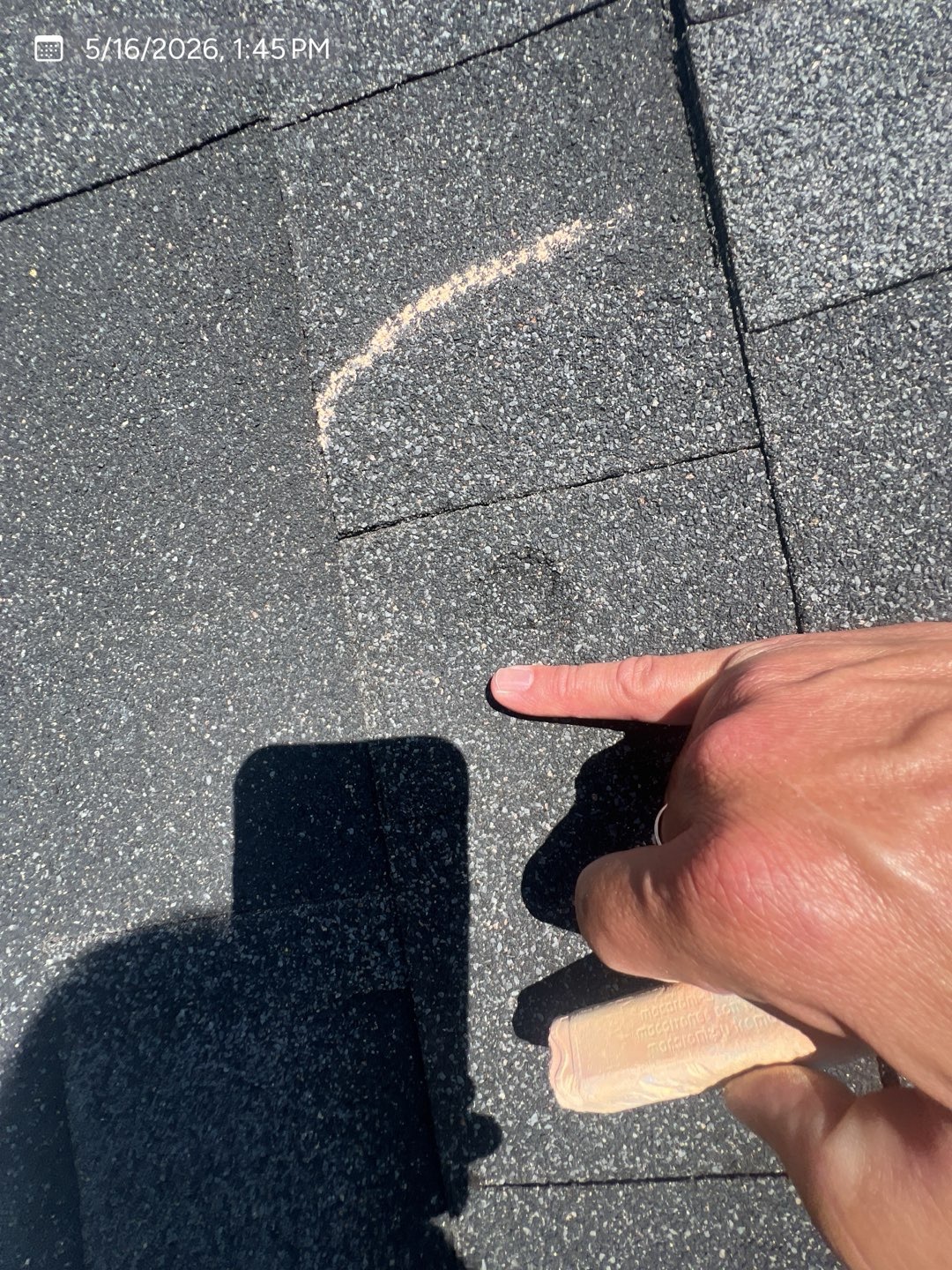 Close-up of a marked shingle impact documented during an MVP inspection
