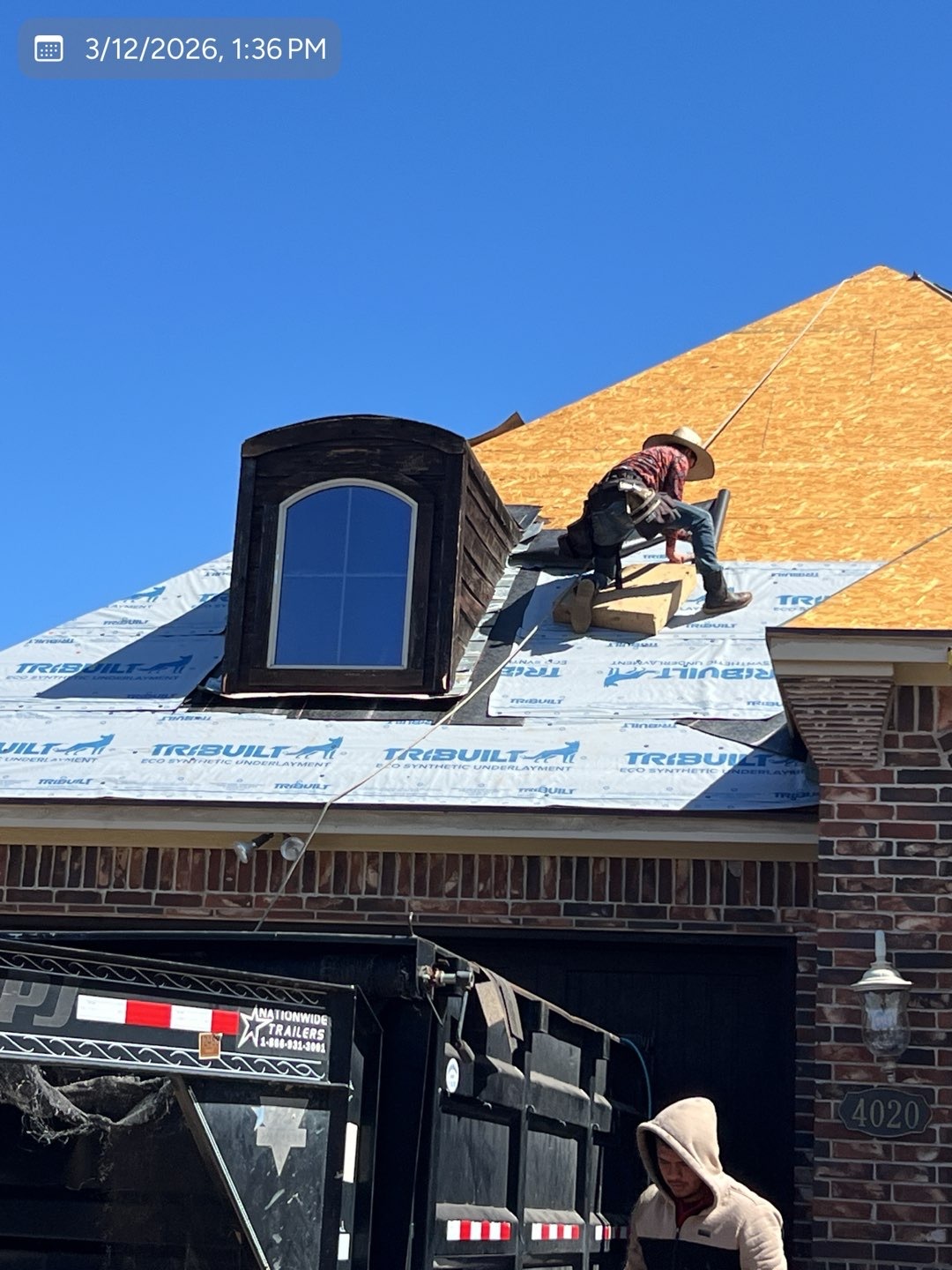 MVP crew member installing synthetic underlayment during a residential roof replacement