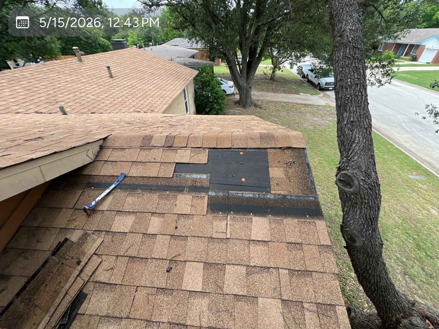 Localized roof repair with shingles removed around the affected area