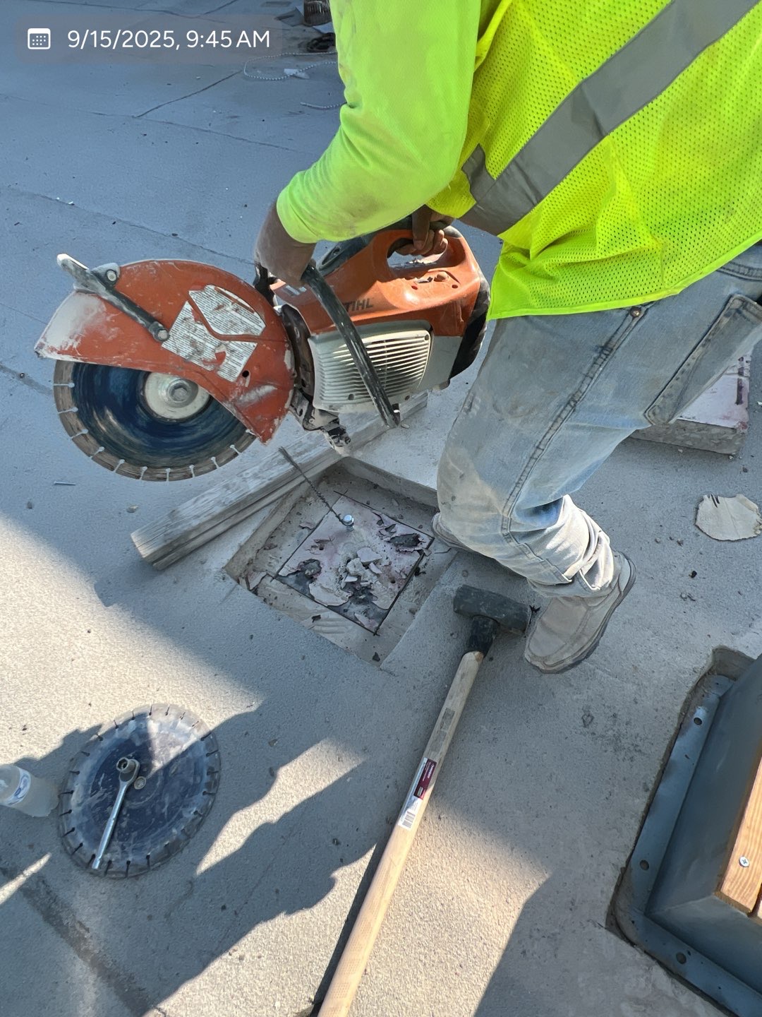 Commercial concrete saw cutting in progress